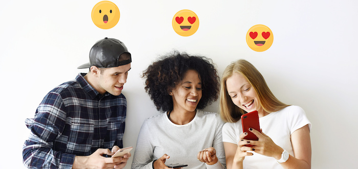 Three young people holding smartphones, with emoji's above their heads